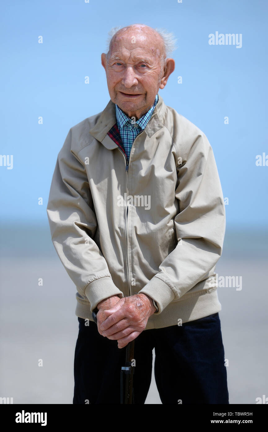 Stanley Elliss, 97, from Ashford, stands on a the beach at Dunkirk, France, on the second day of a trip arranged by the Royal British Legion for D-Day veterans to mark the 75th anniversary of D-Day. Stock Photo