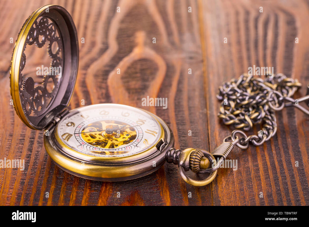 Antique pocket watch lying on an old rustic wood background Stock Photo ...