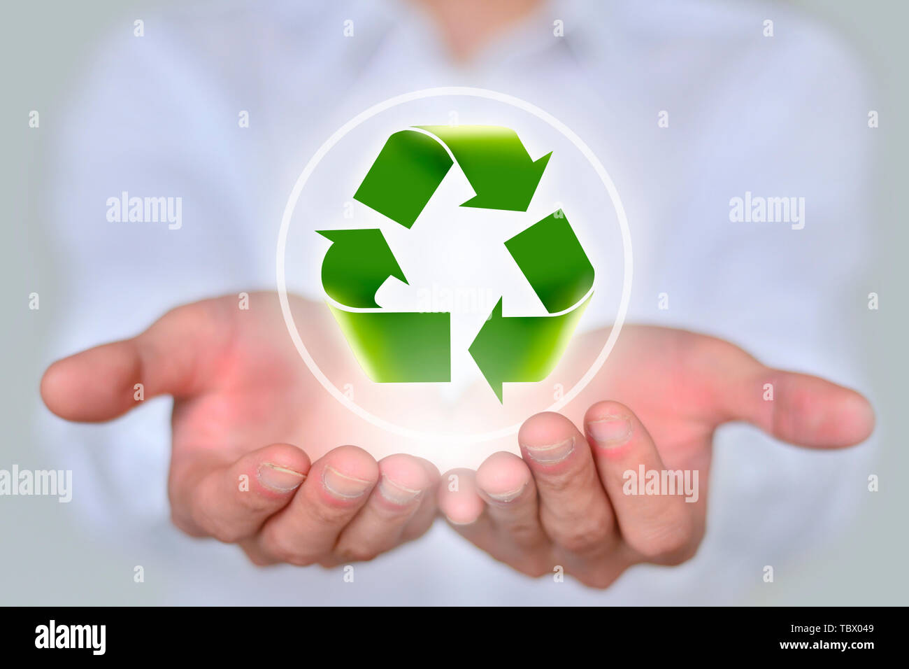 Business man holding recyclable icon in hand Stock Photo - Alamy