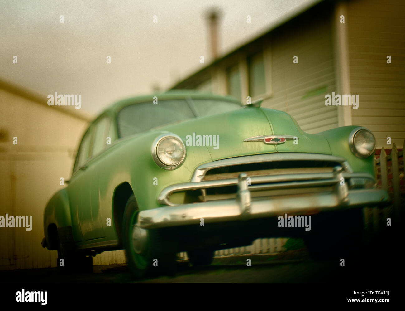 Side view of a vintage car parked near a fence Stock Photo - Alamy