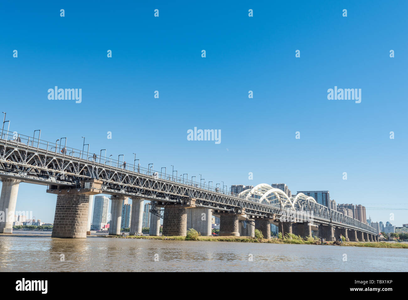 Songhua River Railway Bridge under Autumn Sunny Day in Harbin, China Stock Photo