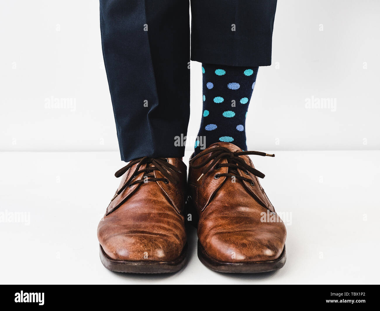 Office manager standing in stylish shoes, blue pants and bright ...