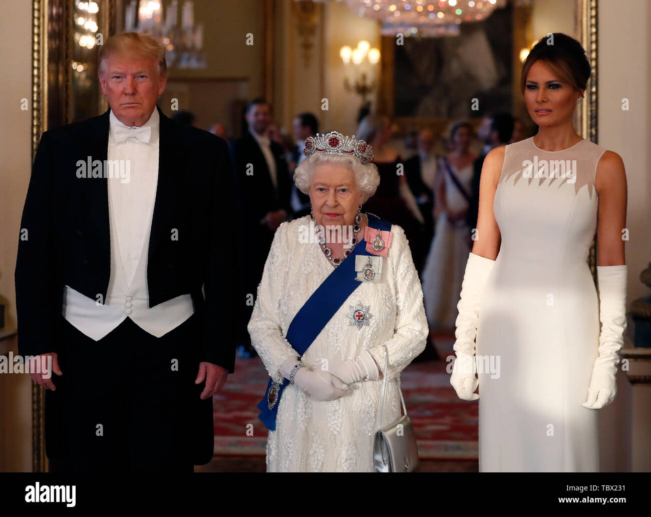 (left to right) US President Donald Trump, Queen Elizabeth II and Melania Trump, during a group photo ahead of the State Banquet at Buckingham Palace, London, on day one of US President Donald Trump's three day state visit to the UK. Stock Photo