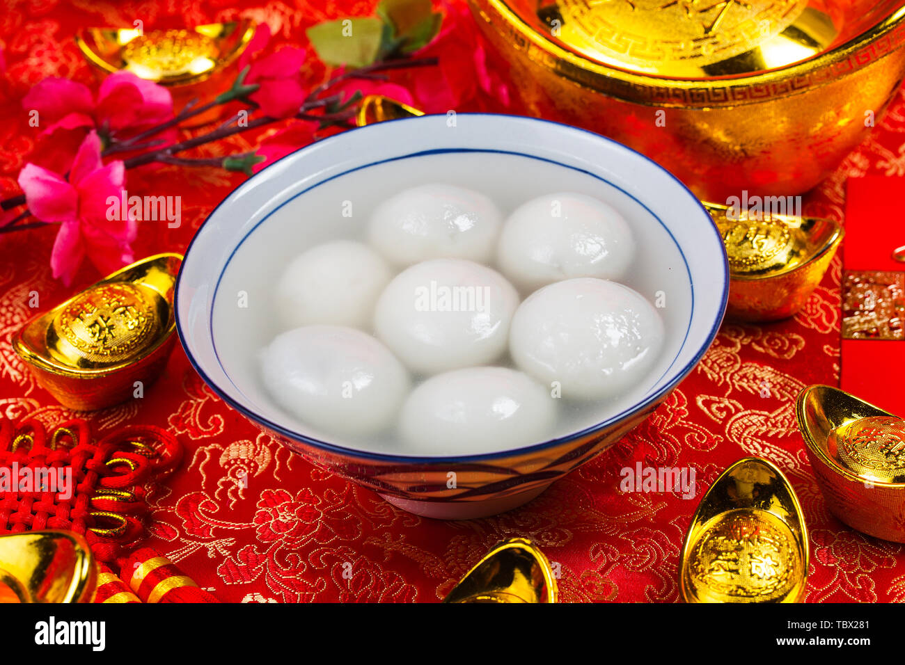 Chinese Lantern Festival food,ang pow or red packet and gold ingots. Chinese characters means luck,wealth and prosperity. Stock Photo