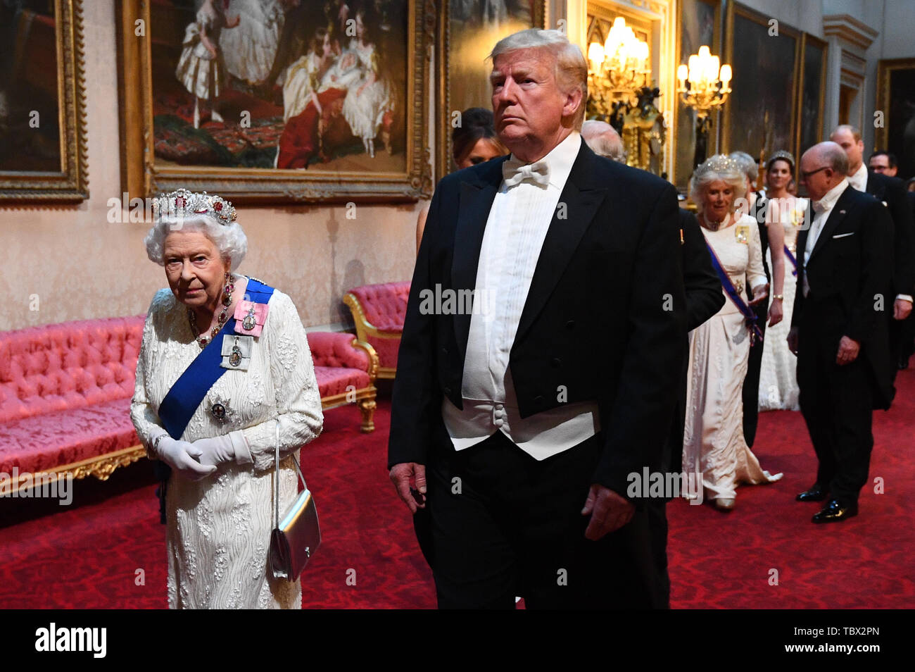 Queen Elizabeth II, US President Donald Trump and the Prince of Wales arrive through the East Gallery during the State Banquet at Buckingham Palace, London, on day one of the US President's three day state visit to the UK. Stock Photo