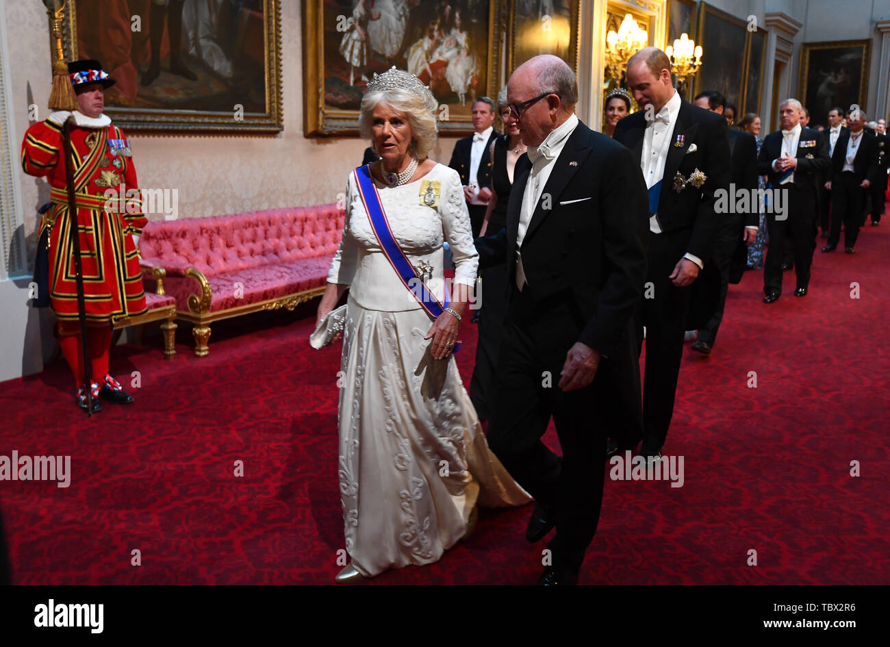 Duchess of Cornwall and Robert Wood Johnson, the United States Ambassador to the United Kingdom, arrive through the East Gallery during the State Banquet at Buckingham Palace, London, on day one of the US President's three day state visit to the UK. Stock Photo