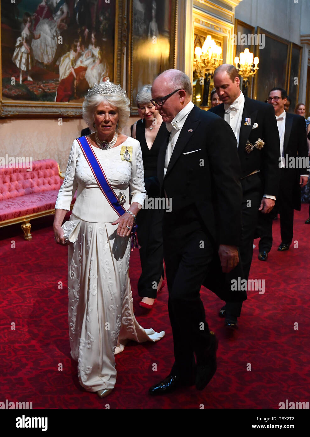 Duchess of Cornwall and Robert Wood Johnson, the United States Ambassador to the United Kingdom, arrive through the East Gallery during the State Banquet at Buckingham Palace, London, on day one of the US President's three day state visit to the UK. Stock Photo