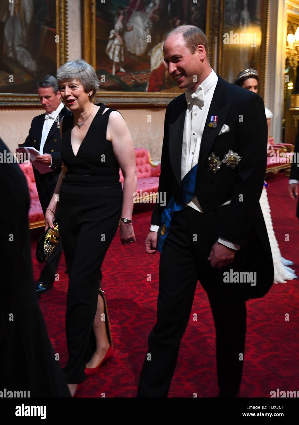 Prime Minister Theresa May and the Duke of Cambridge arrive through the East Gallery during the State Banquet at Buckingham Palace, London, on day one of the US President's three day state visit to the UK. Stock Photo