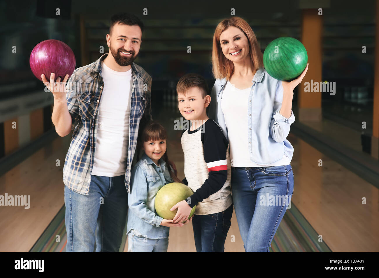 Happy family at bowling club Stock Photo