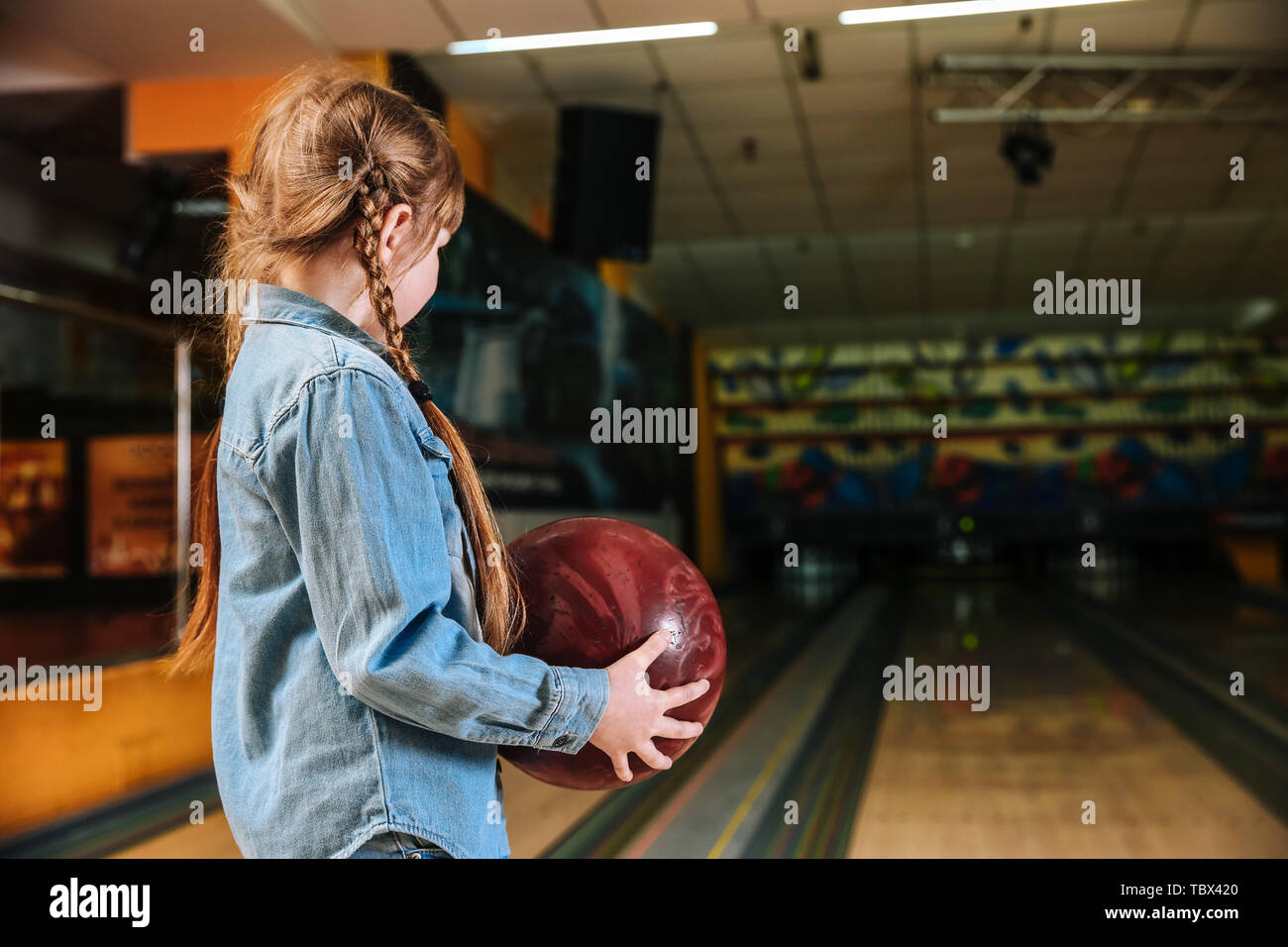 Little girl playing bowling in club Stock Photo Alamy