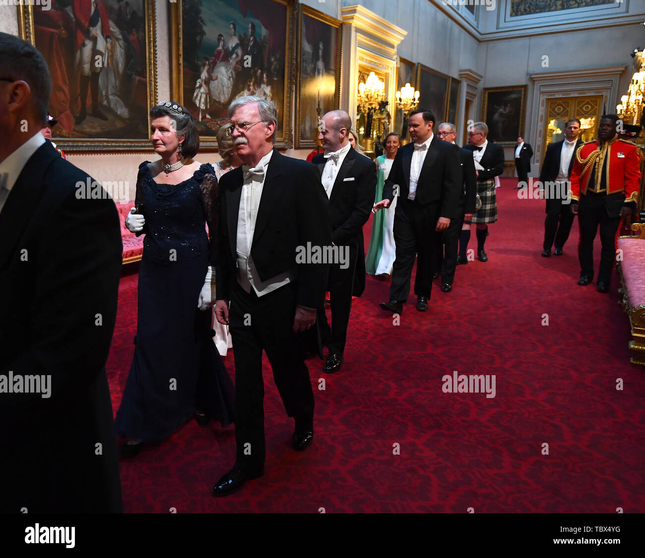 The Viscountess Brookeborough and John R. Bolton arrive through the East Gallery during the State Banquet at Buckingham Palace, London, on day one of the US President's three day state visit to the UK. Stock Photo