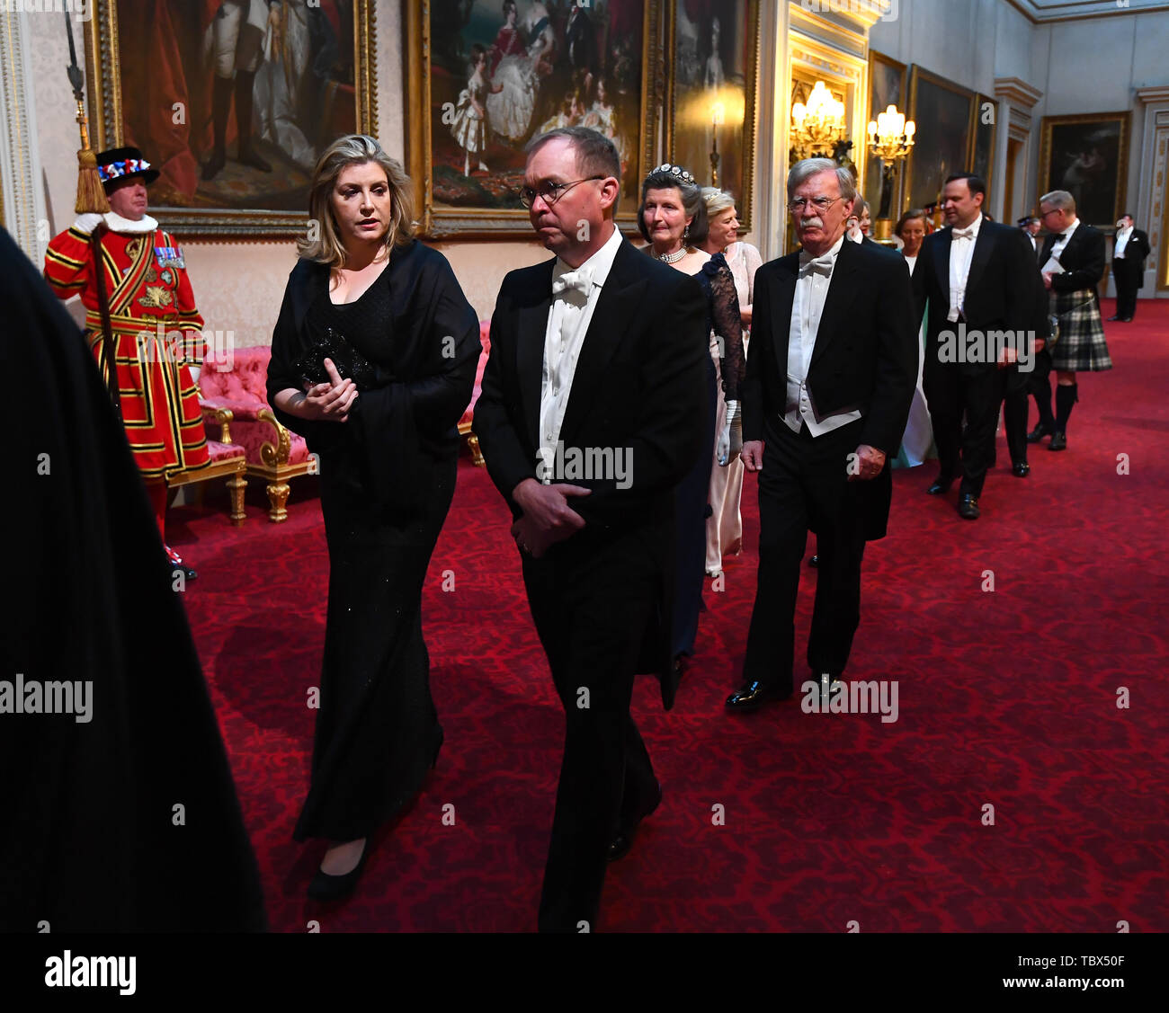 Secretary of State for Defence, Penny Mordaunt and John Michael Mulvaney arrive through the East Gallery during the State Banquet at Buckingham Palace, London, on day one of the US President's three day state visit to the UK. Stock Photo