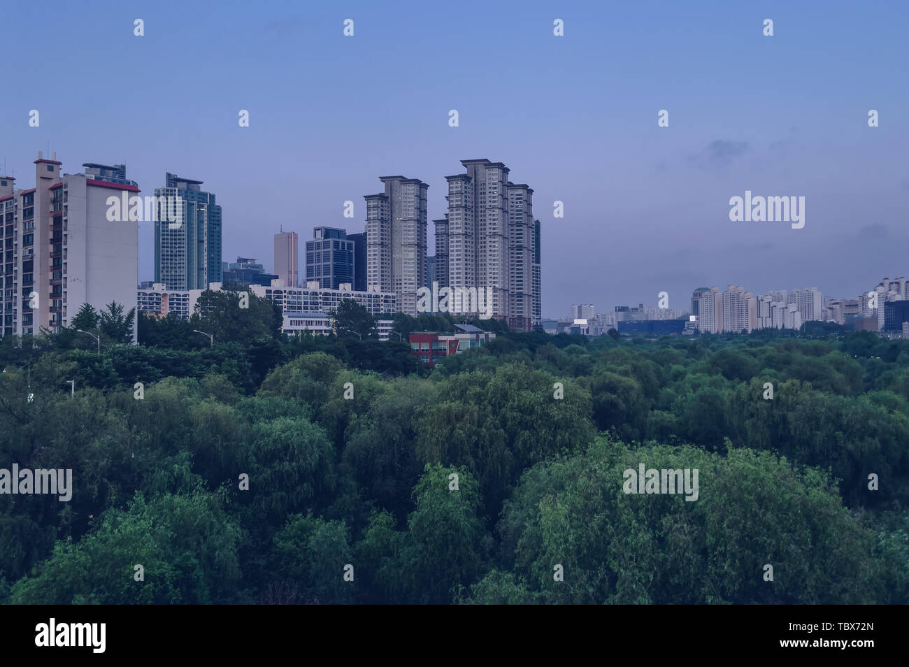 cityscape of Seoul at dusk with Yeouido Park underneath Stock Photo