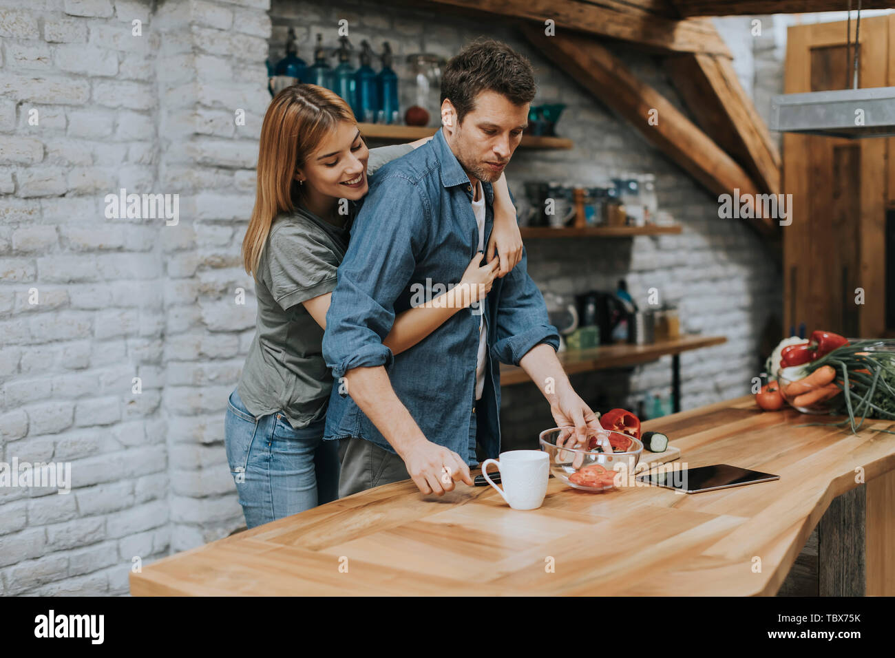 Lovely couple preparing food  in the kitchen Stock Photo