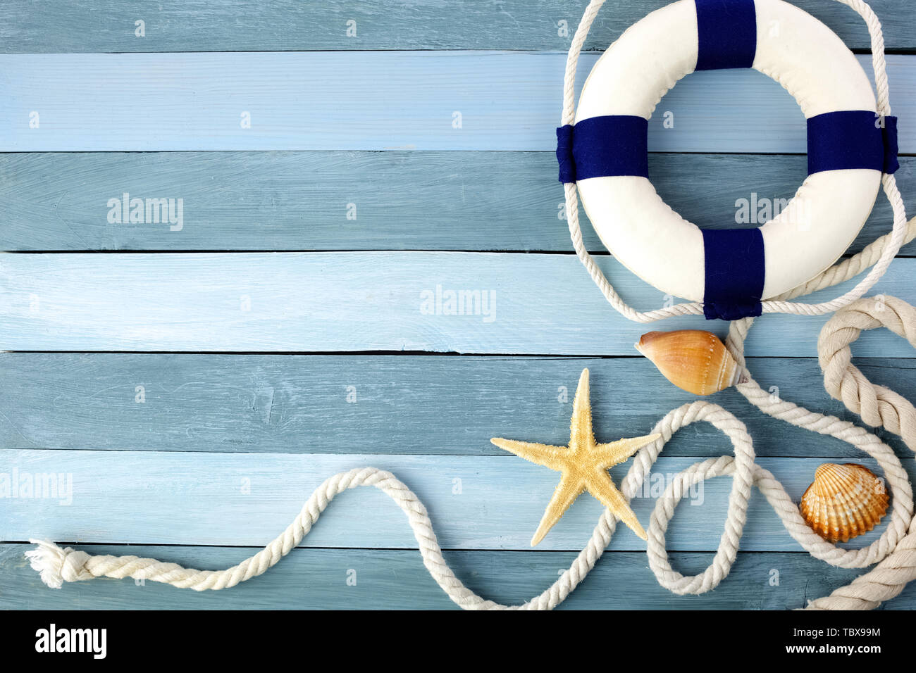 Few summer marine items on a blue wooden background Stock Photo - Alamy