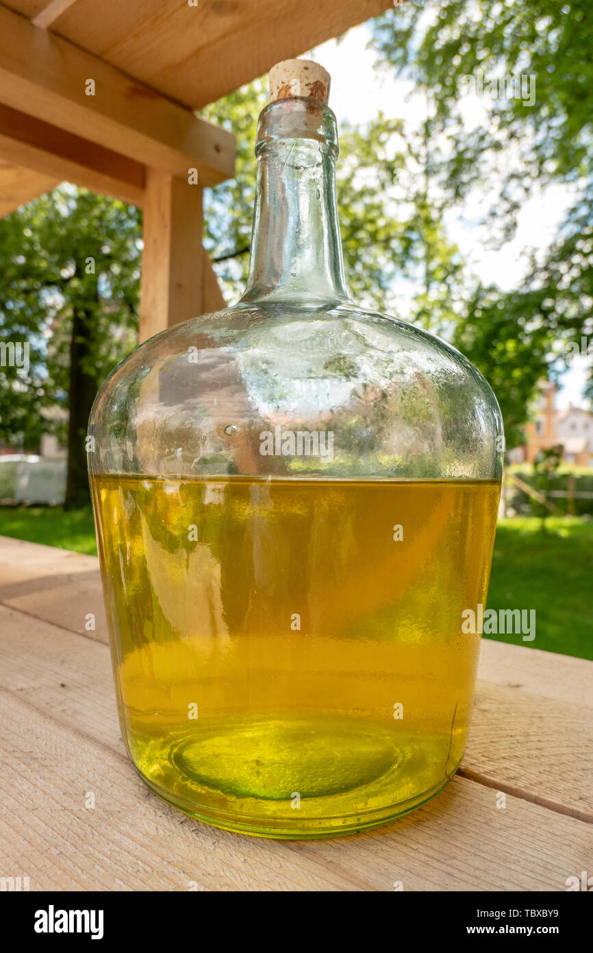 https://c8.alamy.com/comp/TBXBY9/large-antique-glass-bottle-with-yellow-liquid-as-medicine-and-herbal-mixture-TBXBY9.jpg