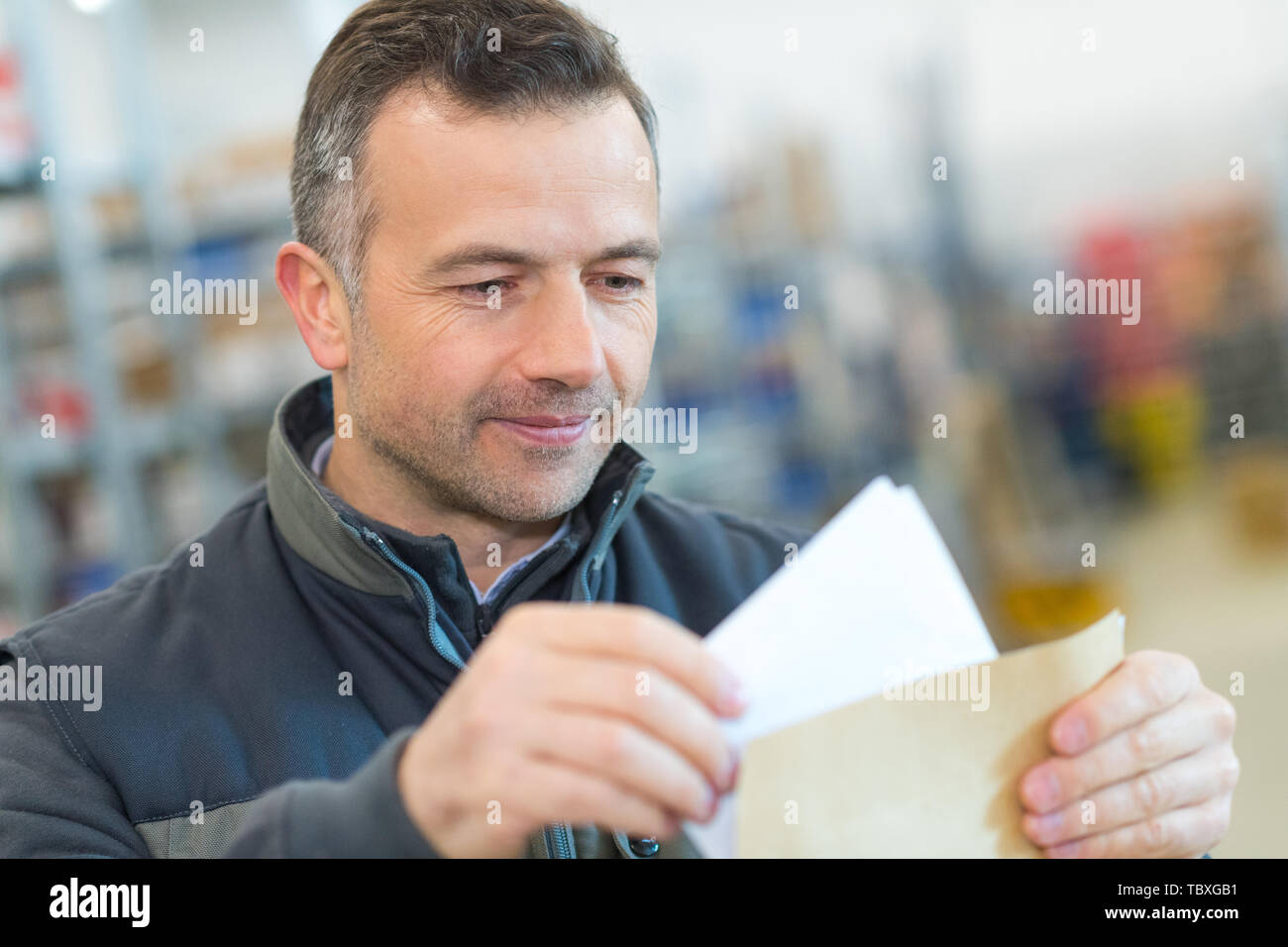 salesman with papers in book store Stock Photo Alamy