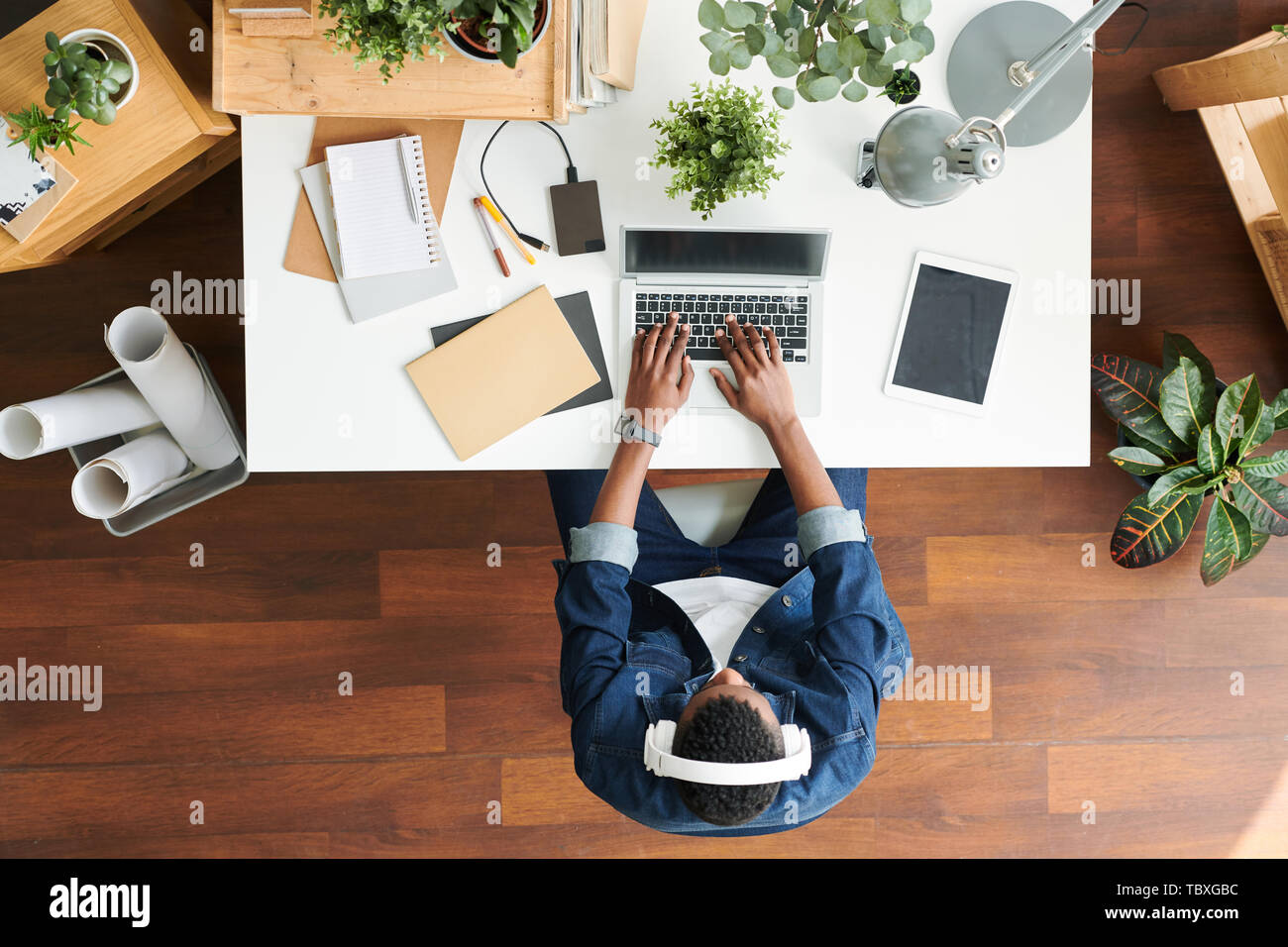 Guy typing by desk Stock Photo