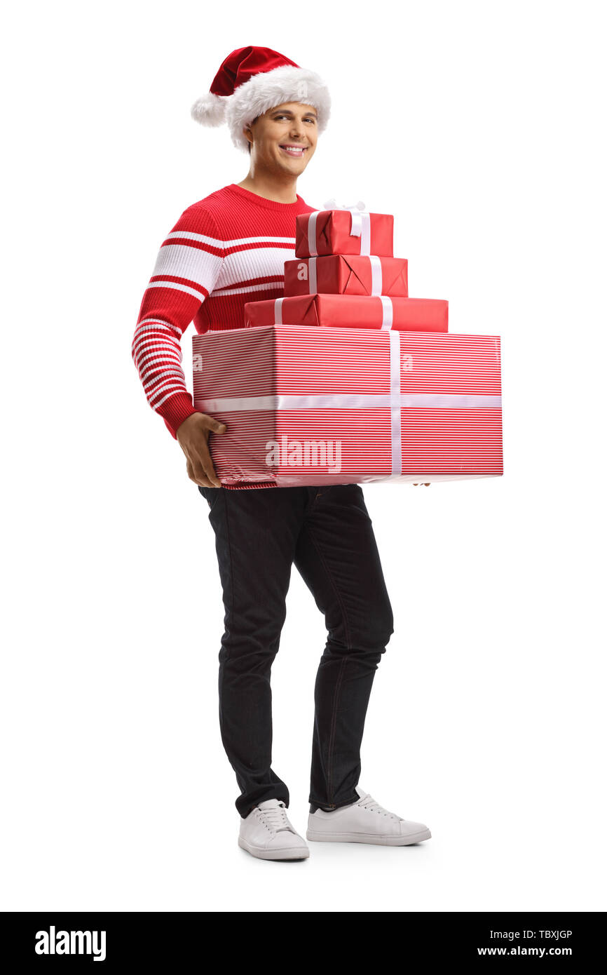 Full length portrait of a young man with a christmas santa hat holding ...