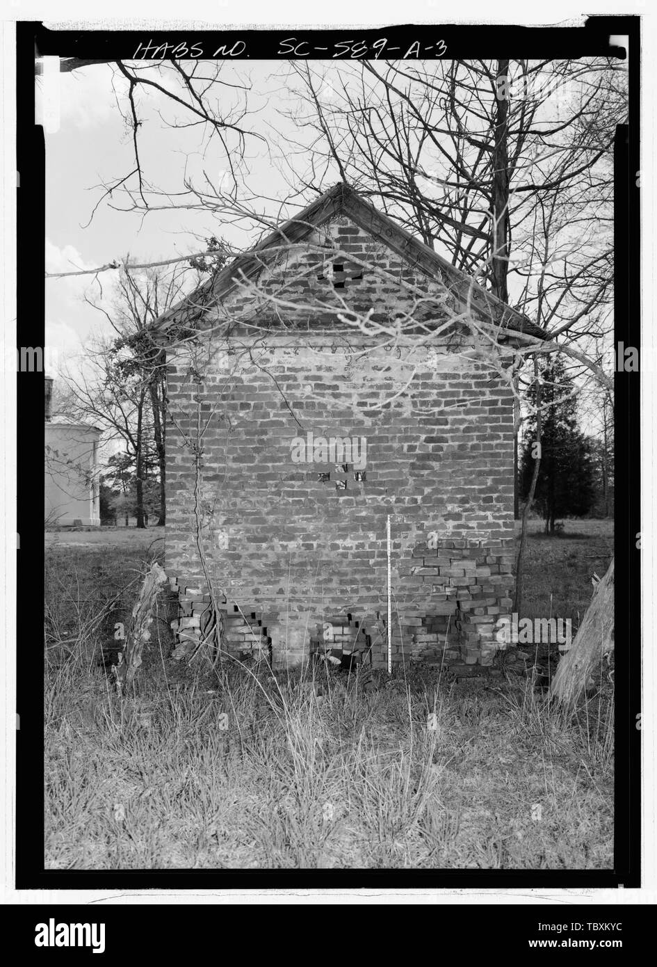 NORTH (REAR) ELEVATION SHOWING SANITARY CLEANOUTS, LOOKING SOUTH, WITH