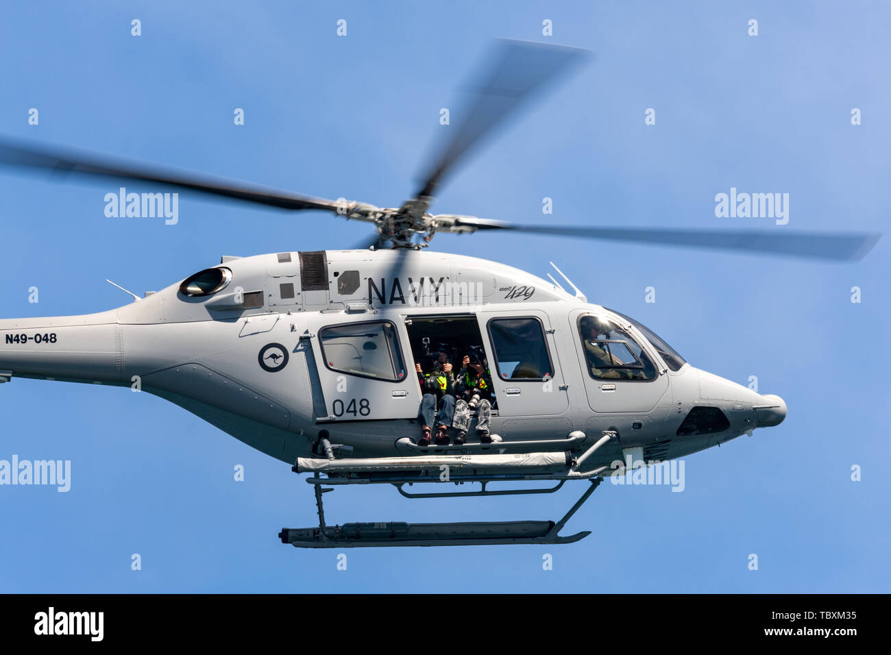 Royal Australian Navy (RAN) Bell 429 Helicopter N49-048 flying over Sydney Harbour. Stock Photo