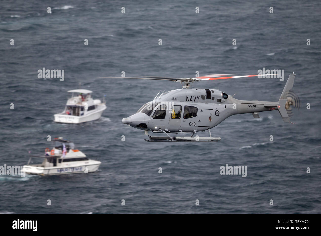 Royal Australian Navy (RAN) Bell 429 Helicopter N49-048 flying over Sydney Harbour. Stock Photo