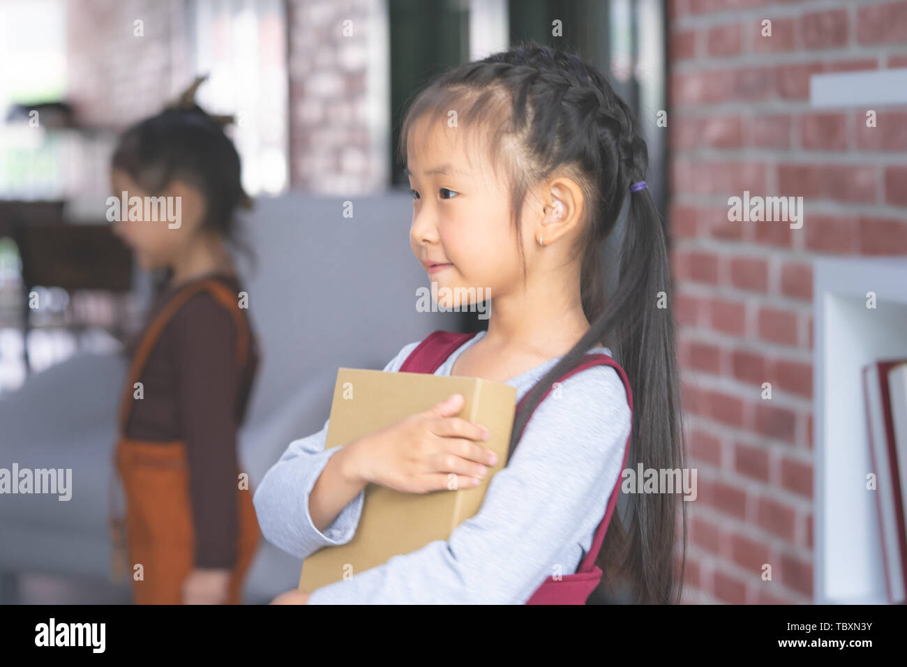 Little girl holding Book for study concept Stock Photo - Alamy