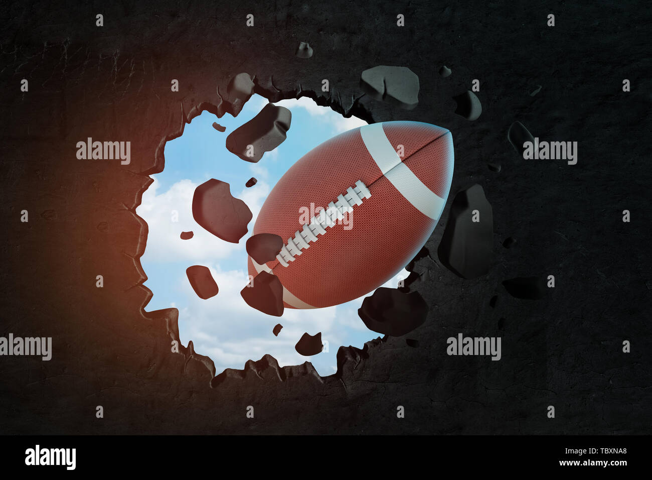 3d closeup rendering of brown oval ball for American football breaking hole in black wall with blue sky seen through hole. Stock Photo