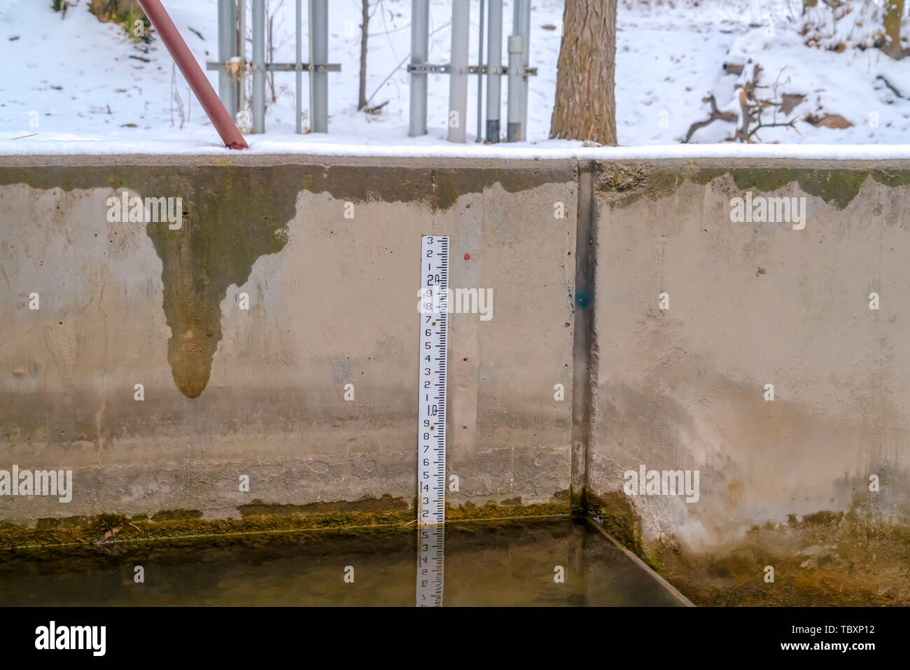 Concrete water tank surrounded by a landscape covered in snow Stock