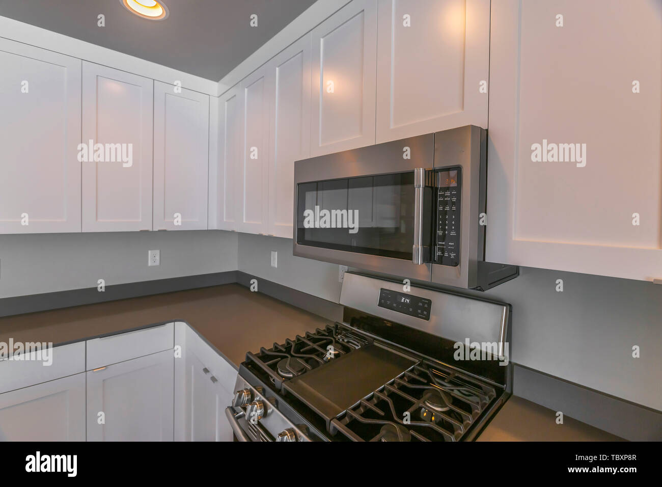 Interior Of A Modern Kitchen With Wooden Cabinets And Round Ceiling Lights Stock Photo Alamy