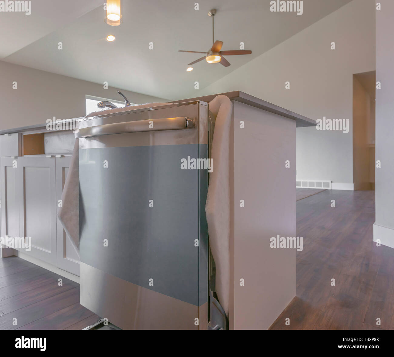 Close up of the dishwasher on a kitchen island inside a room with wooden floor Stock Photo Alamy