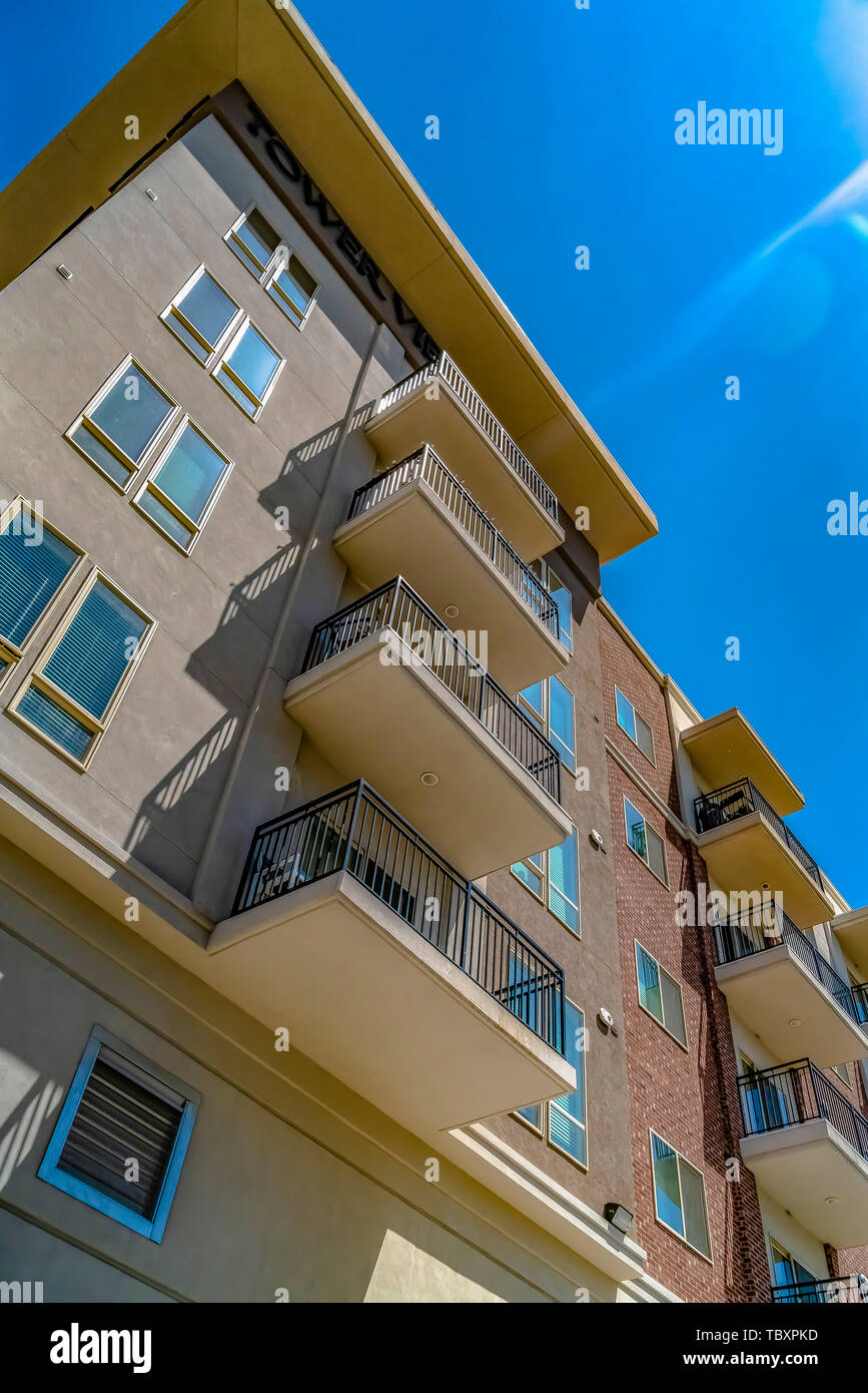 View from below of a building with small balconies on a sunny day Stock ...