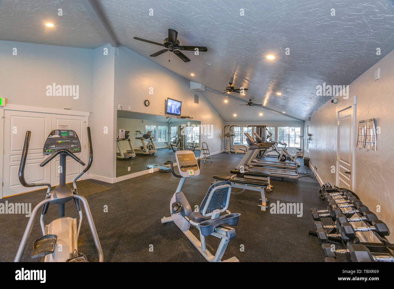 Interior of a spacious fitness gym with various exercise equipment Stock Photo