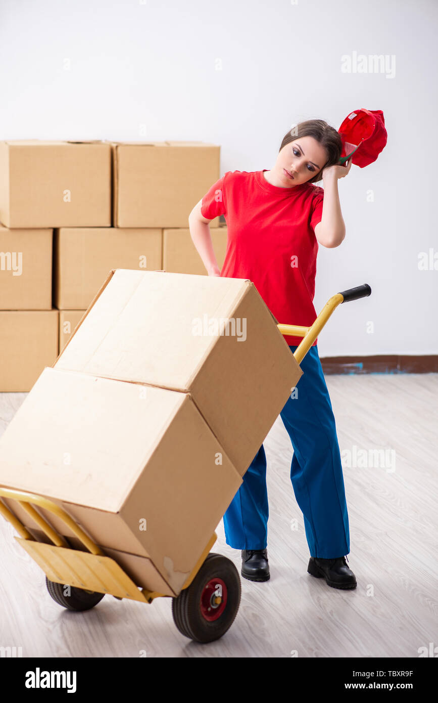 Young female professional mover doing home relocation Stock Photo