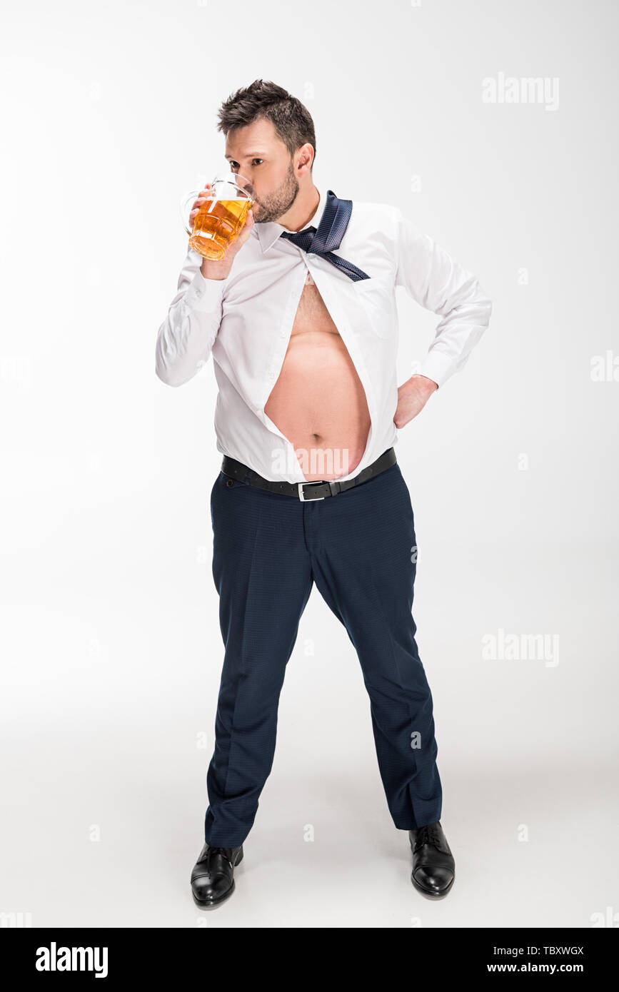 overweight man in tight shirt drinking glass of beer on white Stock Photo -  Alamy