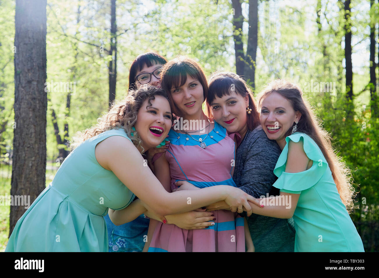 Group of female friends walking in summer or spring park. Women and ...