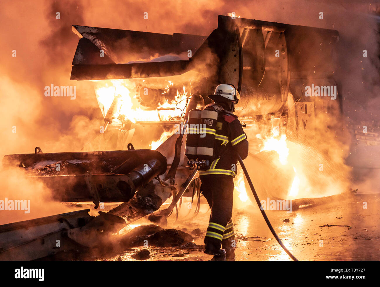 Reichenbach, Germany. 04th June, 2019. Firefighters in Reichenbach near Idar-Oberstein extinguish the fire at a garbage dump. Household waste had caught fire early Tuesday morning on an area of around 200 square metres for reasons that had not yet been clarified. Around 90 firefighters from the surrounding fire brigades and the German Federal Armed Forces were involved in the extinguishing work. Credit: Christian Schulz/dpa/Alamy Live News Stock Photo