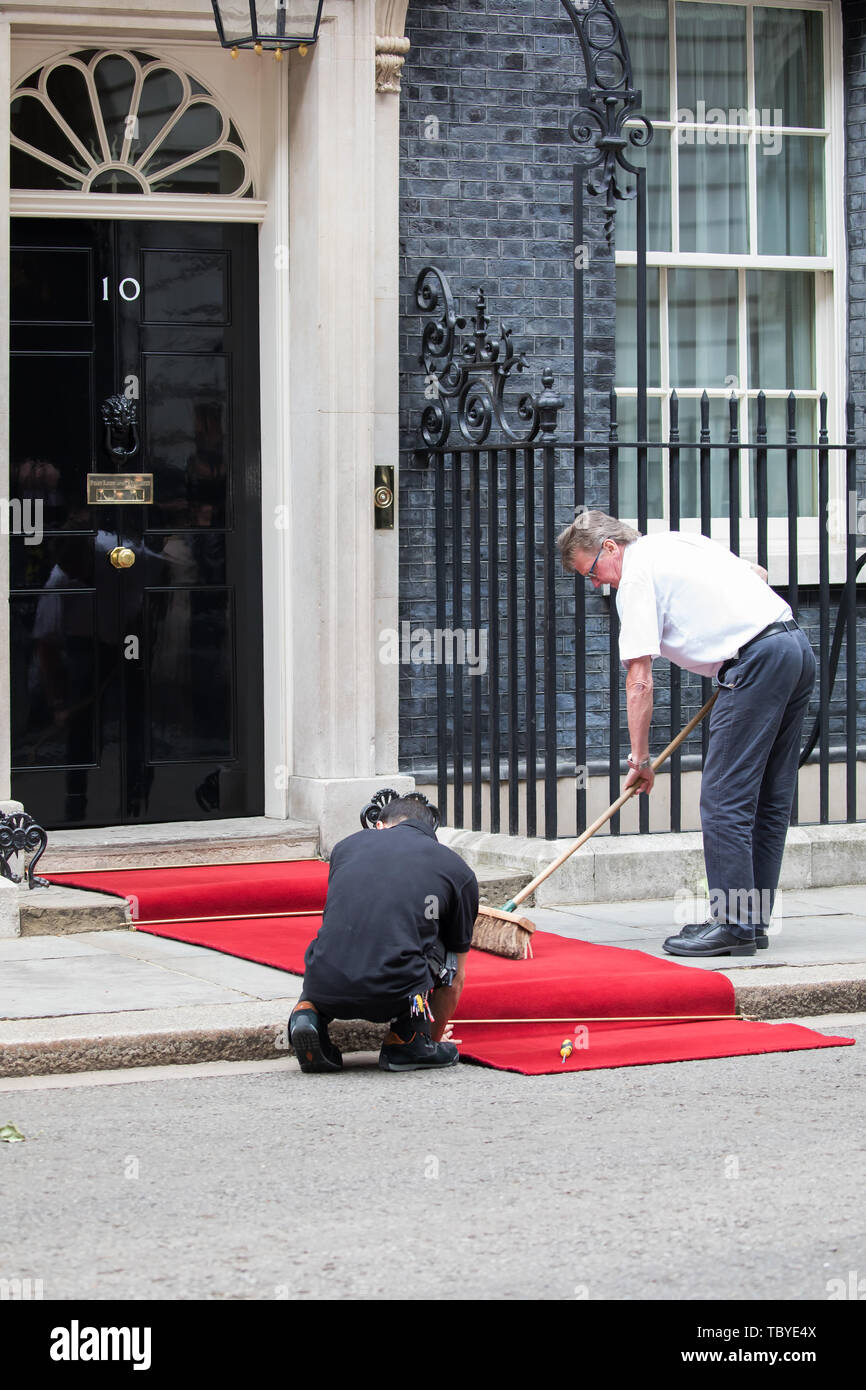 London, UK. 4th June, 2019. Two men Roll out the red carpet ready for the arrival of President Trump in Downing Street. Credit: Keith Larby/Alamy Live News Stock Photo