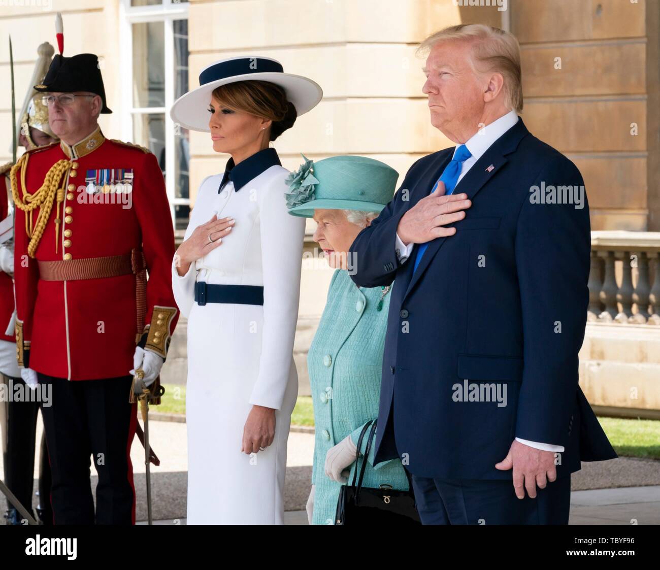 London, UK. 03rd June, 2019. U.S President Donald Trump, stands with First Lady Melania Trump, and Queen Elizabeth II for the national anthems during the official welcoming ceremony at Buckingham Palace June 3, 2019 in London, England. Credit: Planetpix/Alamy Live News Stock Photo