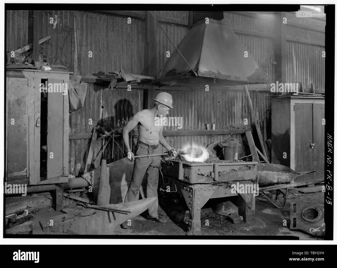 Man working at blacksmith's forge.  Hacienda Mercedita Foundry, Sabanetas, Ponce Municipio, PR Buffalo Forge Company Serralles, Serralles Serralles, Sebastian Marcial Serralles y Colon, Juan Eugenio Serralles, Felix Pont y Puig, Teresa Colon, Juana Perez, Mercedes Serralles, Merceces Serralles, Pedro Juan Serralles, Nicanor Mirrlees Watson and Company Yearby, Jean, transmitter Boucher, Jack, photographer NistalMoret, Benjamin, historian Sanchez, Hector, historian Stock Photo