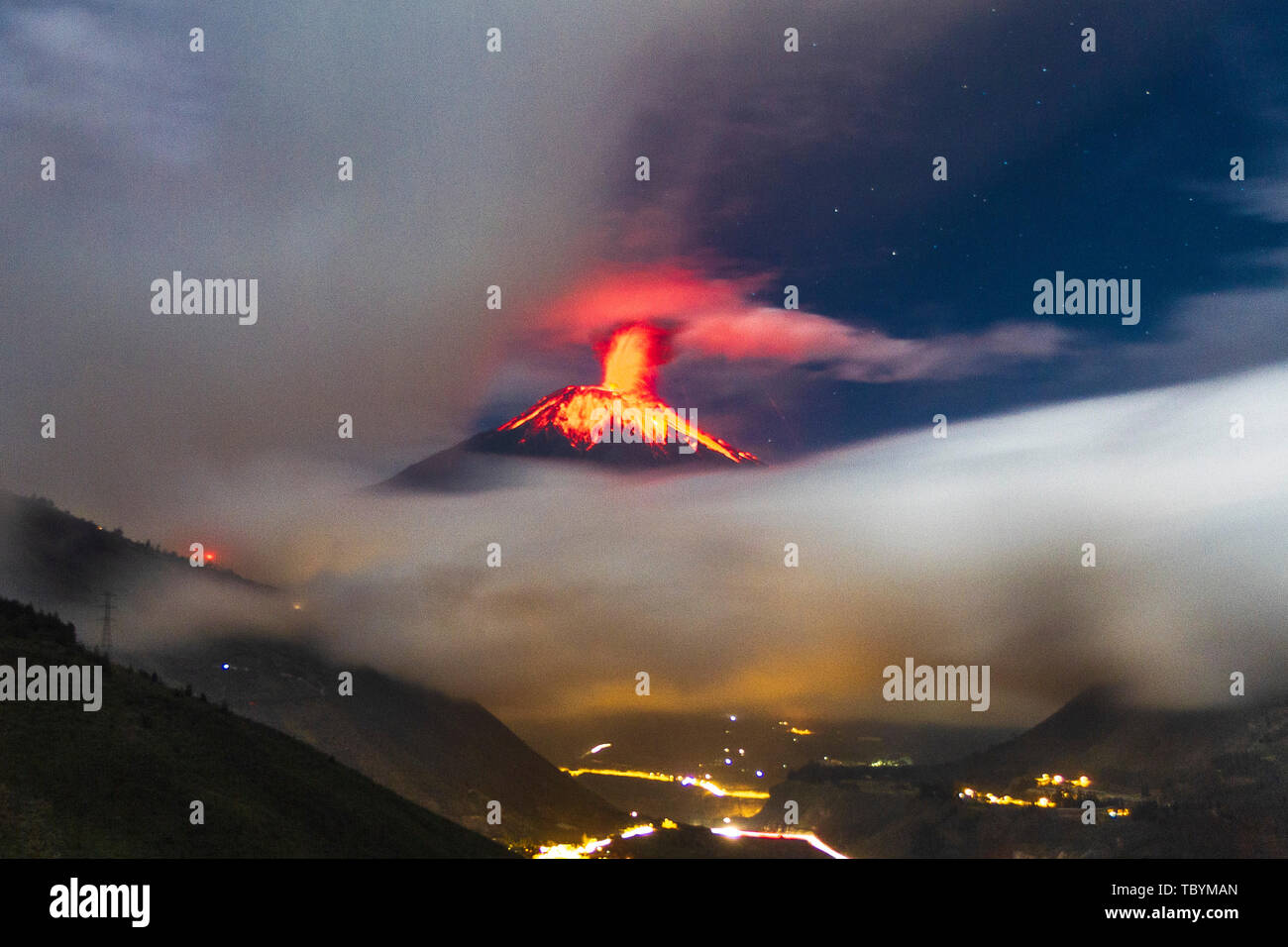 Volcanic eruption shown in Tungurahua volcano with Banos city Stock Photo