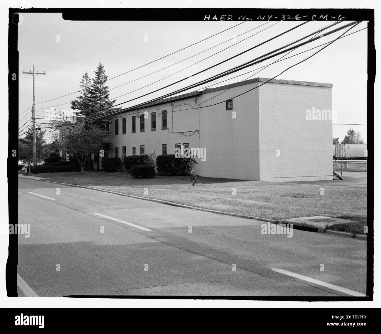 NORTH (SIDE) AND EAST (FRONT) ELEVATIONS OF BUILDING. VIEW TO SOUTH