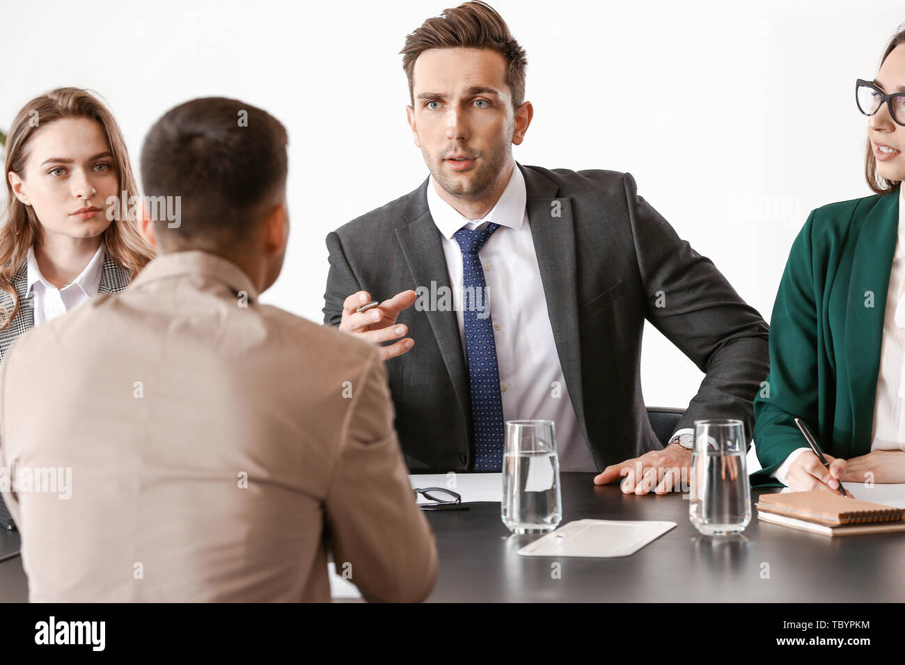 Human resources commission interviewing man in office Stock Photo - Alamy