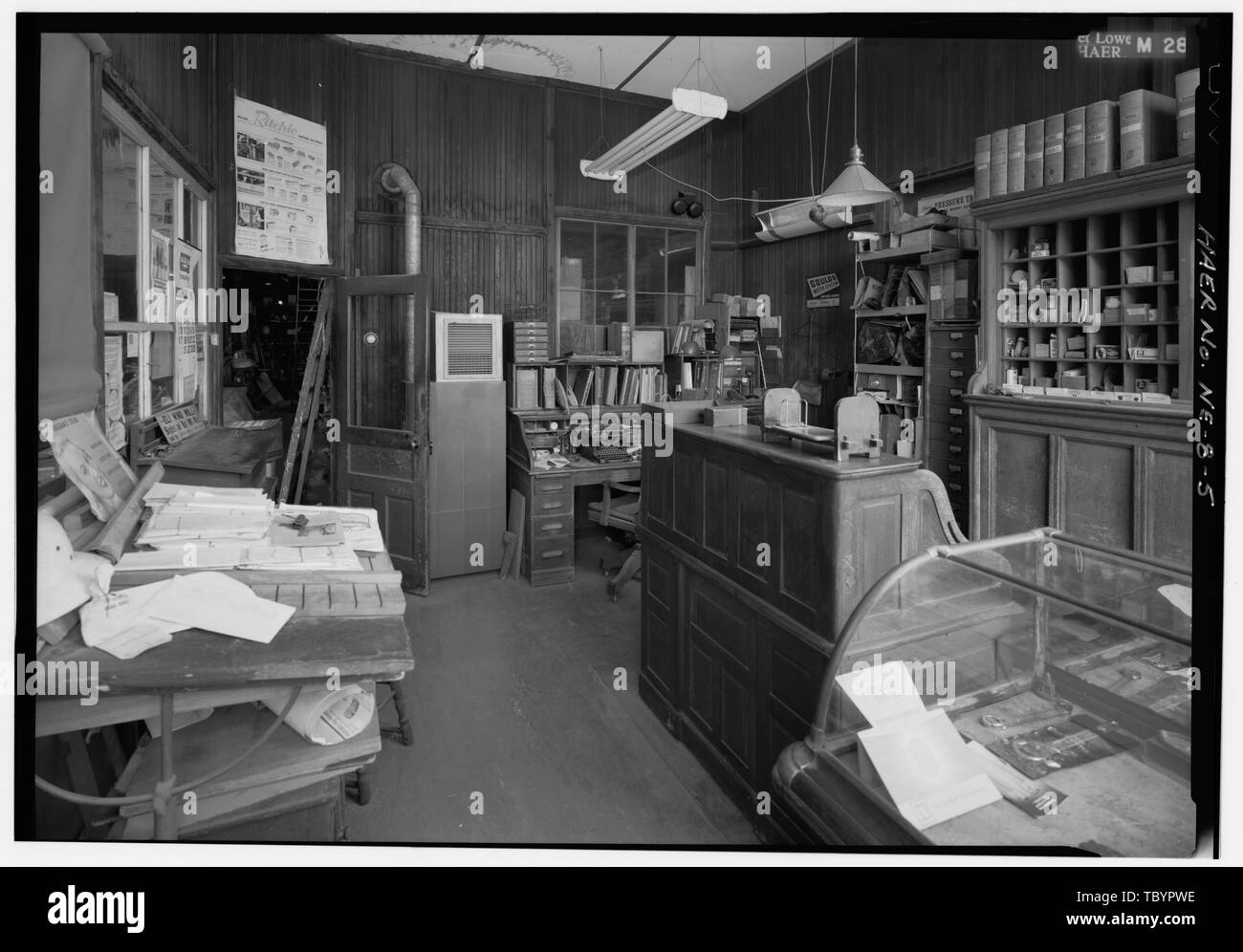 NORTH ACROSS INTERIOR OF OFFICE IN SOUTHEAST CORNER OF BUILDING FROM DOORWAY IN SOUTH FRONT, SHOWING DRAFTING TABLE, MERCHANDISE DISPLAY CASE, DESKS, AND OFFICE FIXTURESBUSINESS MACHINES.  Kregel Windmill Company Factory, 1416 Central Avenue, Nebraska City, Otoe County, NE Stock Photo