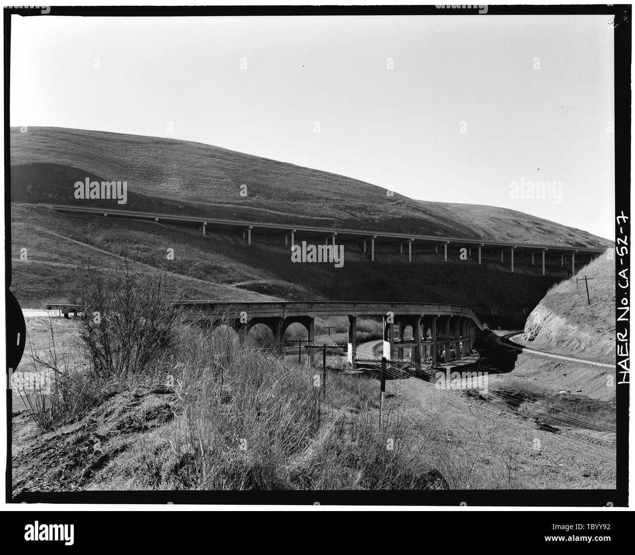 North elevation from shoulder of Altamont Pass Road Interstate Highway 5 viaduct in background former Western Pacific (now Union Pacific) Railroad at right abandoned Southern Pacific right of way beneath bridge view to southwest 90 mm lens  Carroll Overhead Bridge, Altamont Pass Road, Livermore, Alameda County, CA Stock Photo