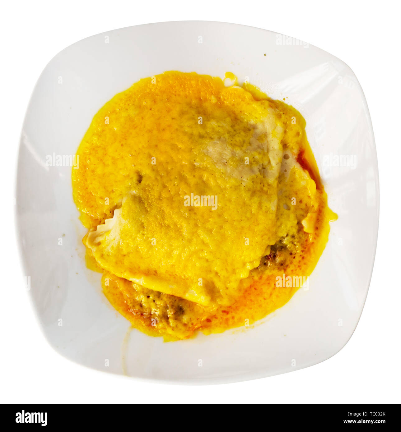 Top view of slice of traditional meat lasagna with bechamel sauce topped with grated cheese served on white plate. Isolated over white background Stock Photo