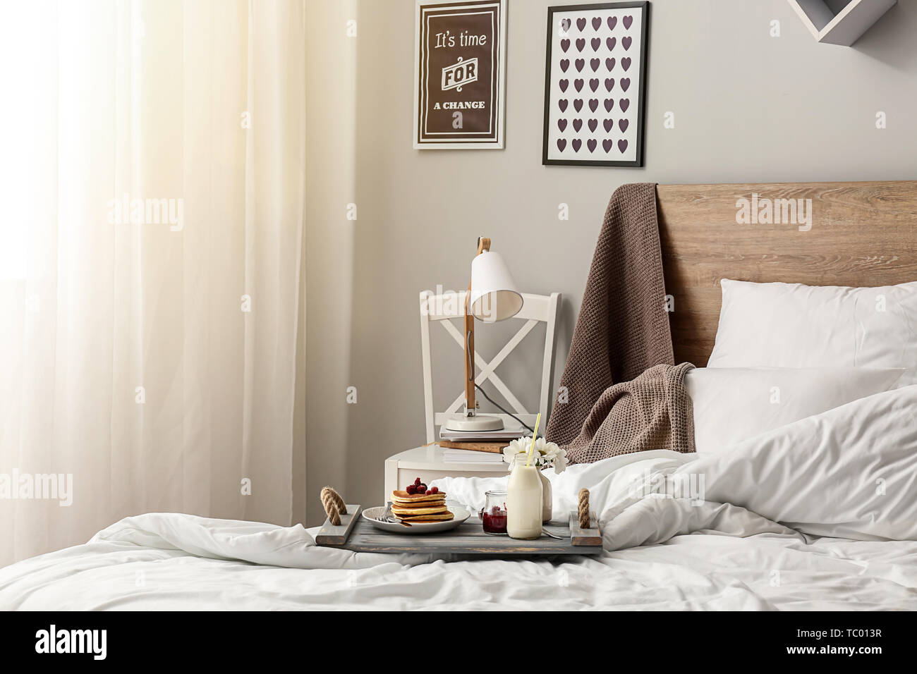 Tasty breakfast on bed in interior of room Stock Photo - Alamy