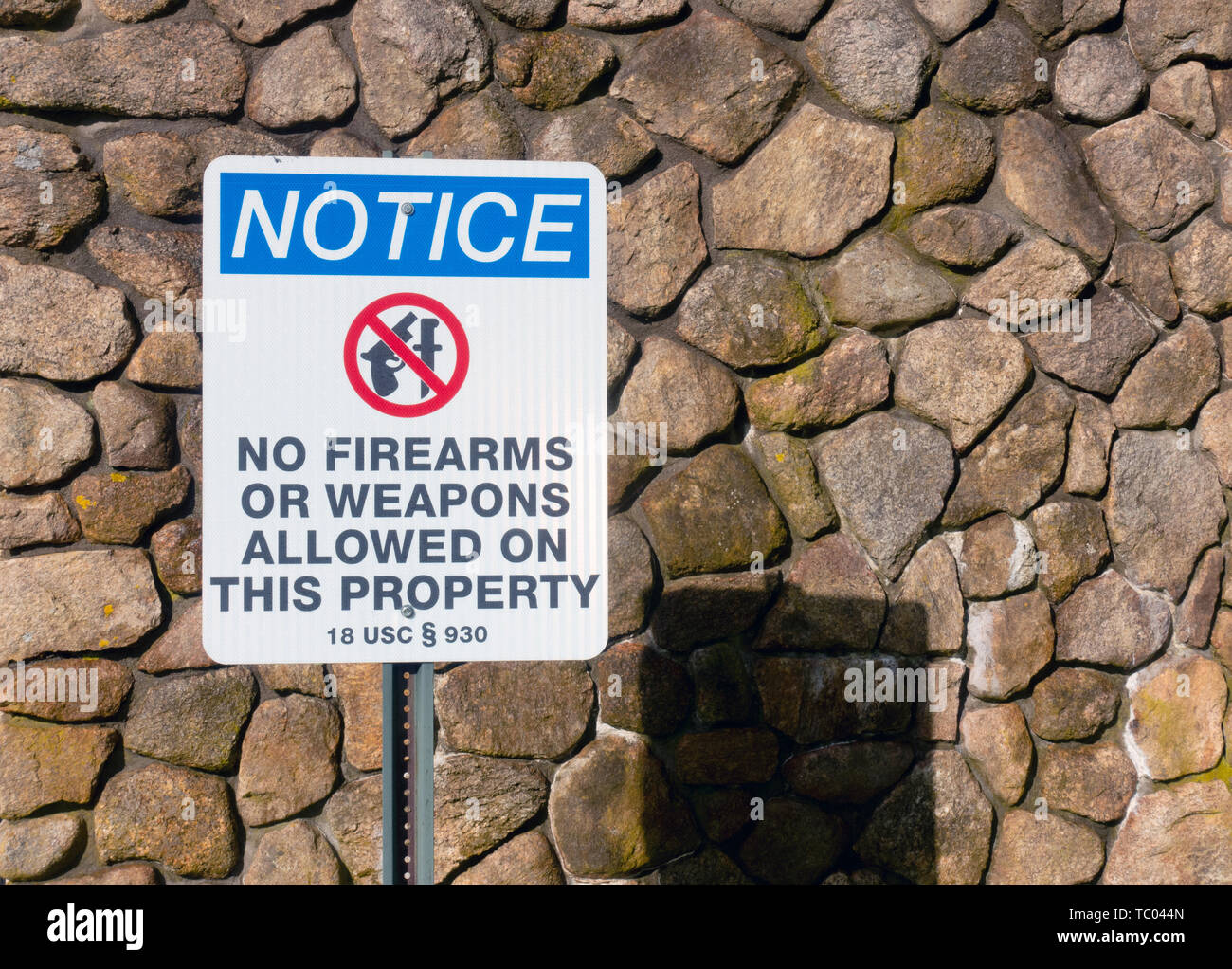 Warning sign notice no firearms or weapons allowed on this property at entrance to the National Cemetery in Bourne, Cape Cod, Massachusetts USA Stock Photo