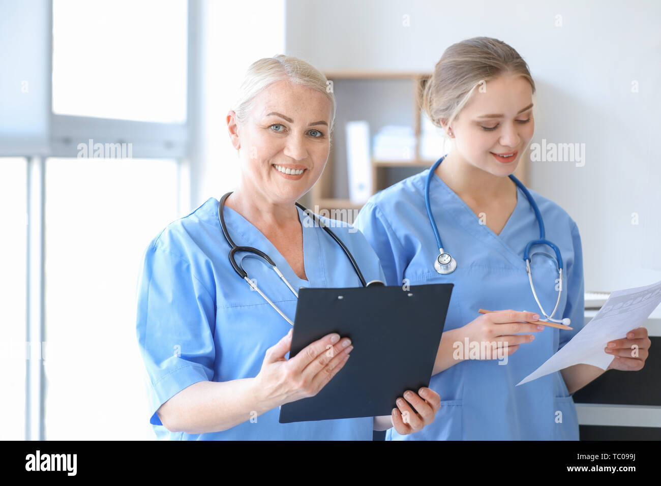 Medical assistants discussing results of laboratory tests in clinic