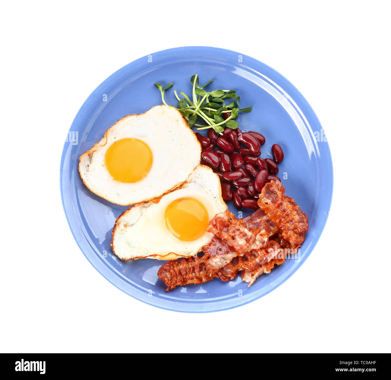 Plate with tasty fried eggs, bacon and beans on white background Stock ...